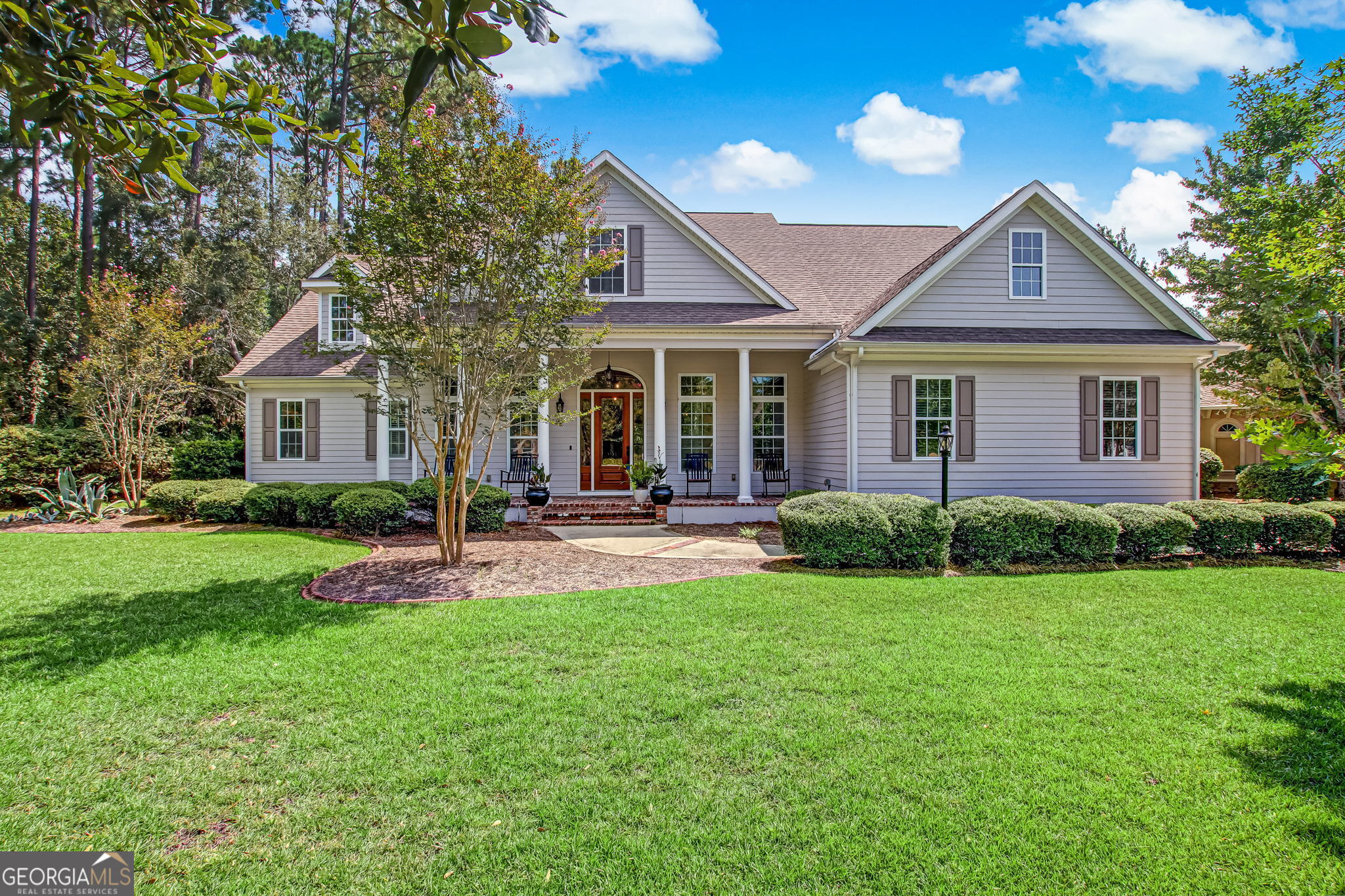 a front view of a house with a yard and porch