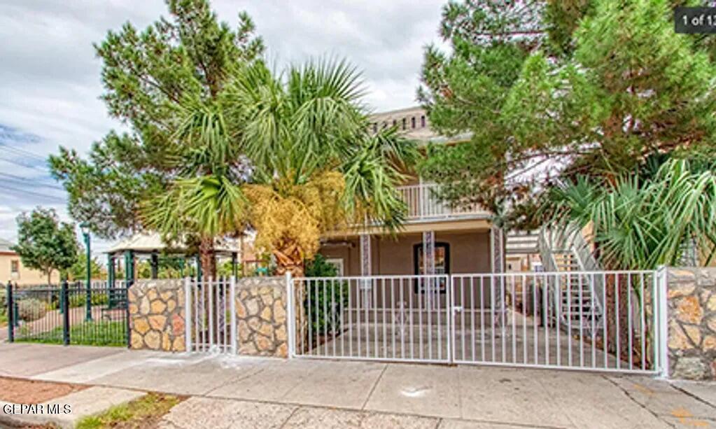 a view of a house with a fence