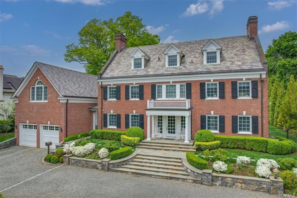 View of the spectacular classic red brick colonial in Scarsdale's Quaker Ridge neighborhood.