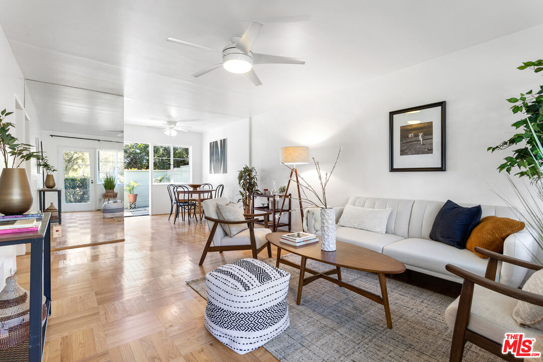 a living room with furniture a rug and a chandelier