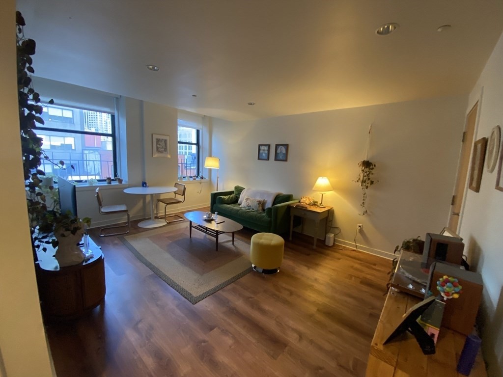 a living room with furniture a lamp and a window