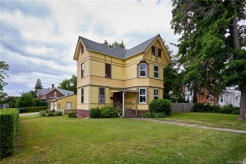 a front view of house with yard and green space