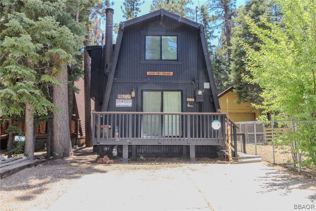 a front view of a house with a fence