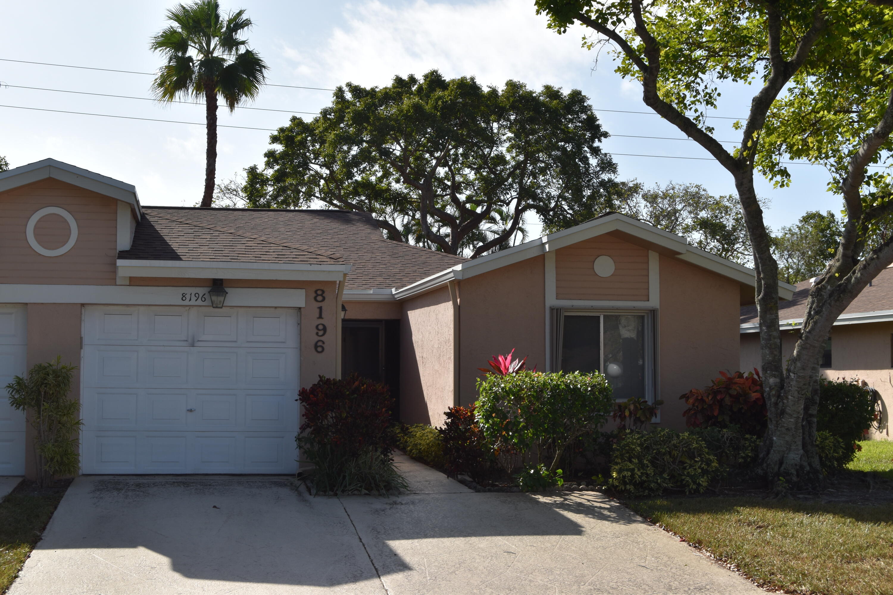 a front view of house with yard and trees