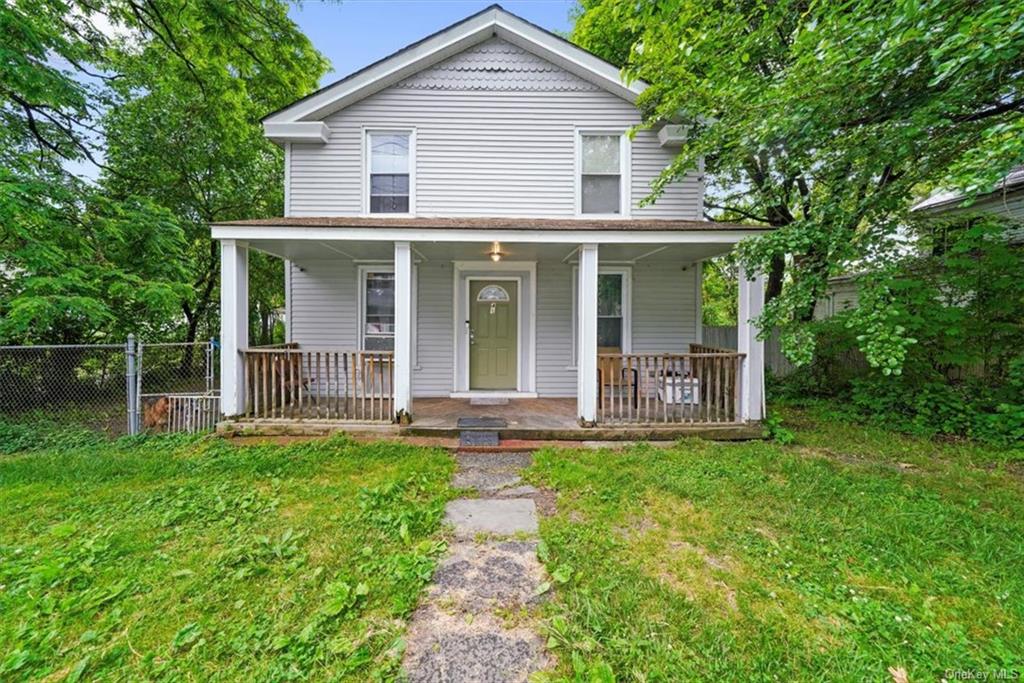 a view of a house with a yard and sitting area