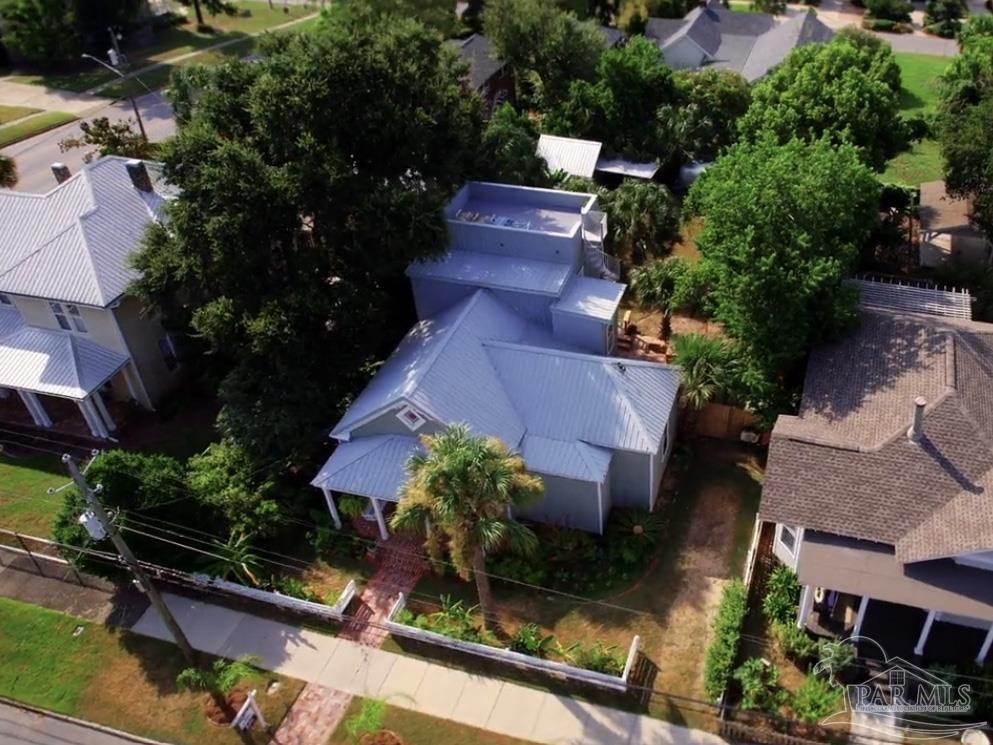 an aerial view of house with yard swimming pool and outdoor seating