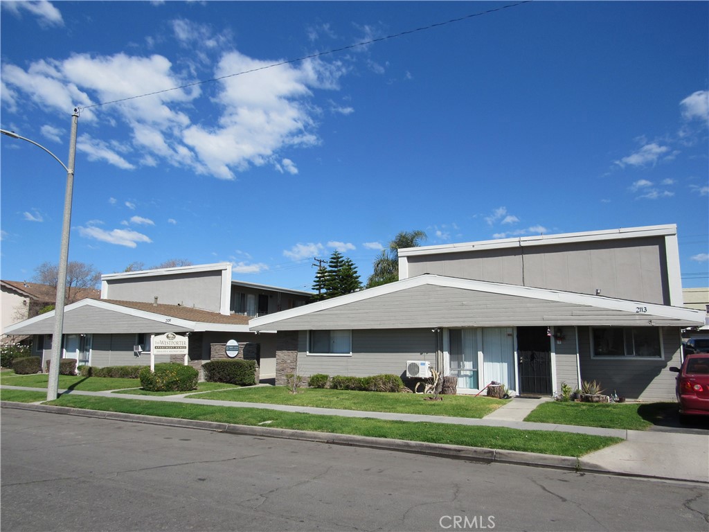 a front view of a building with a yard