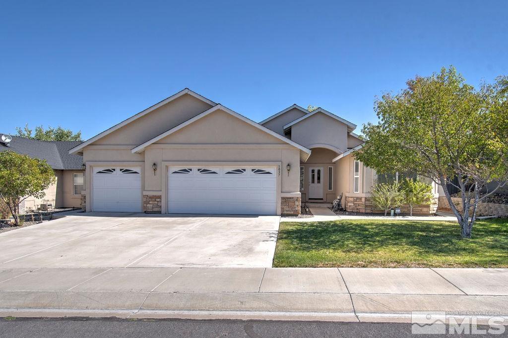 a front view of a house with a yard and garage