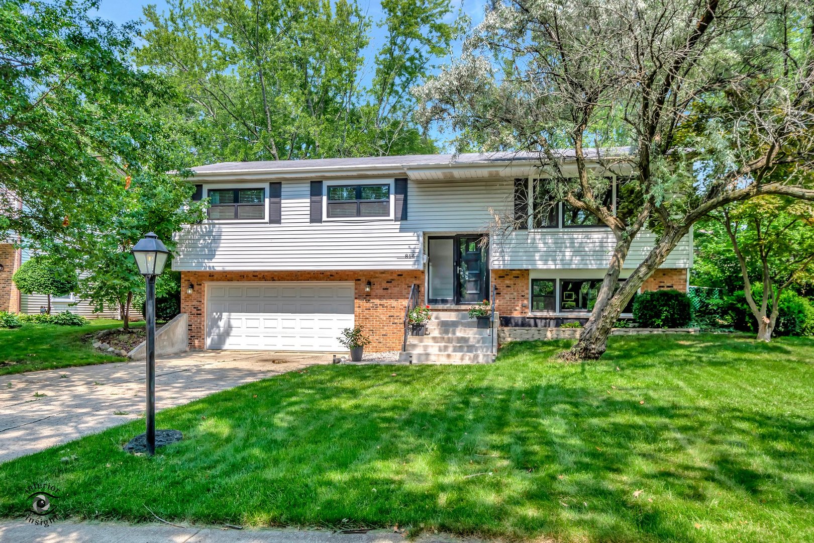 a view of a house with a yard and sitting area