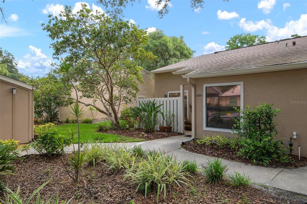 a front view of a house with garden