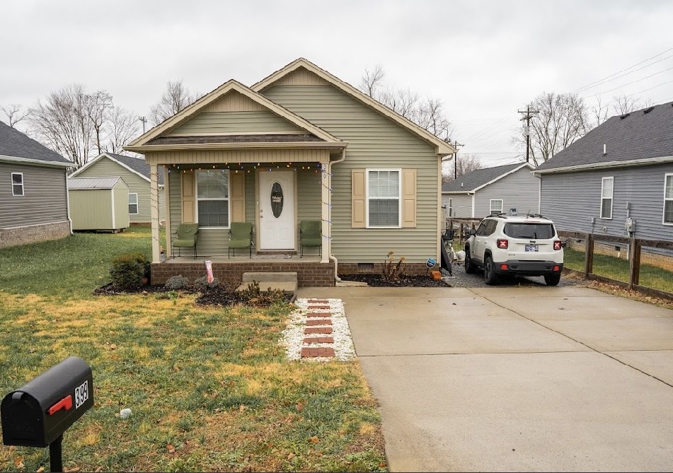 a front view of a house with cars parked