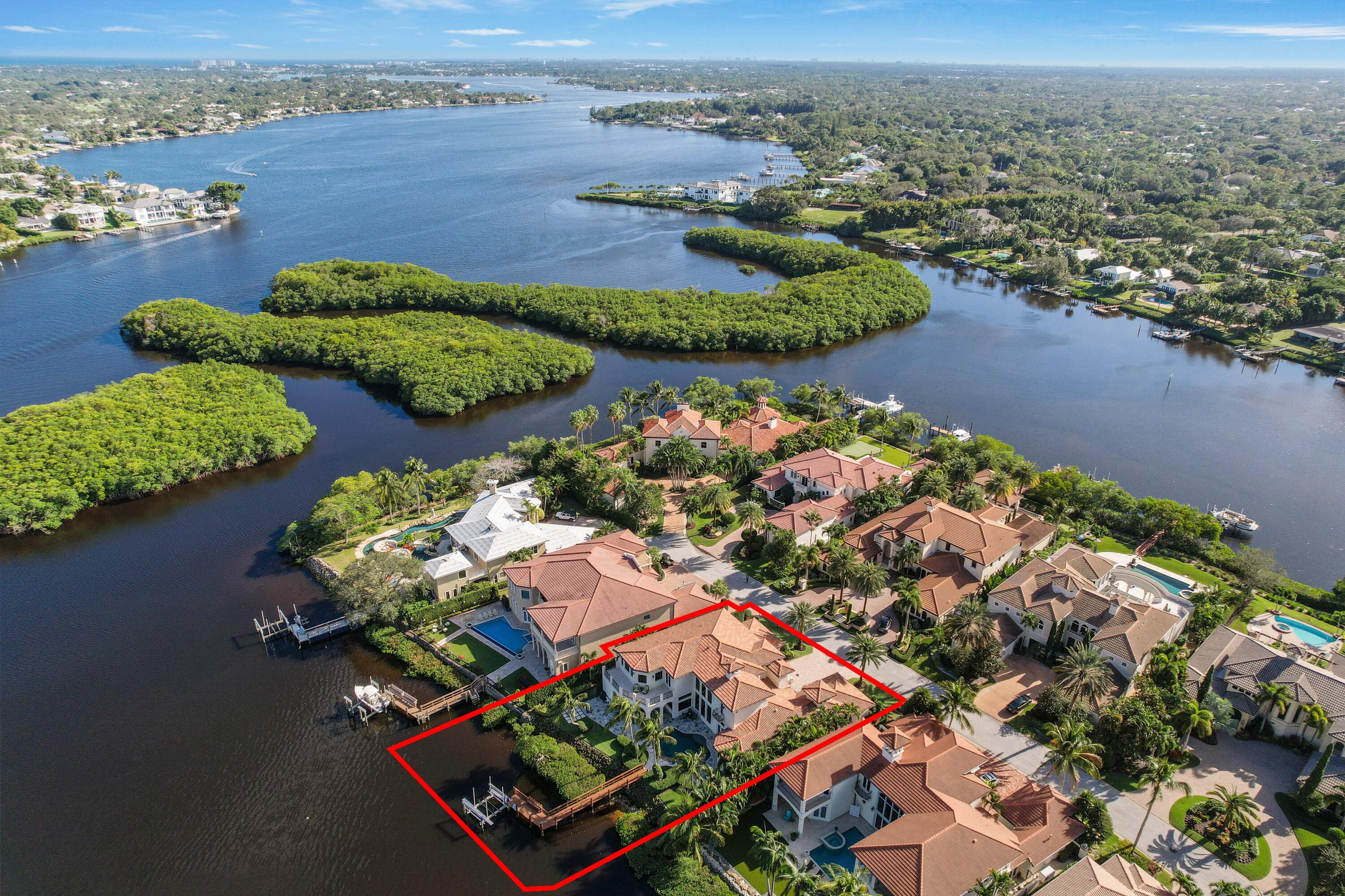 an aerial view of lake and residential houses with outdoor space