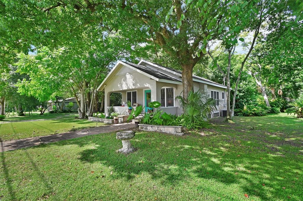 a front view of a house with a yard table and chairs