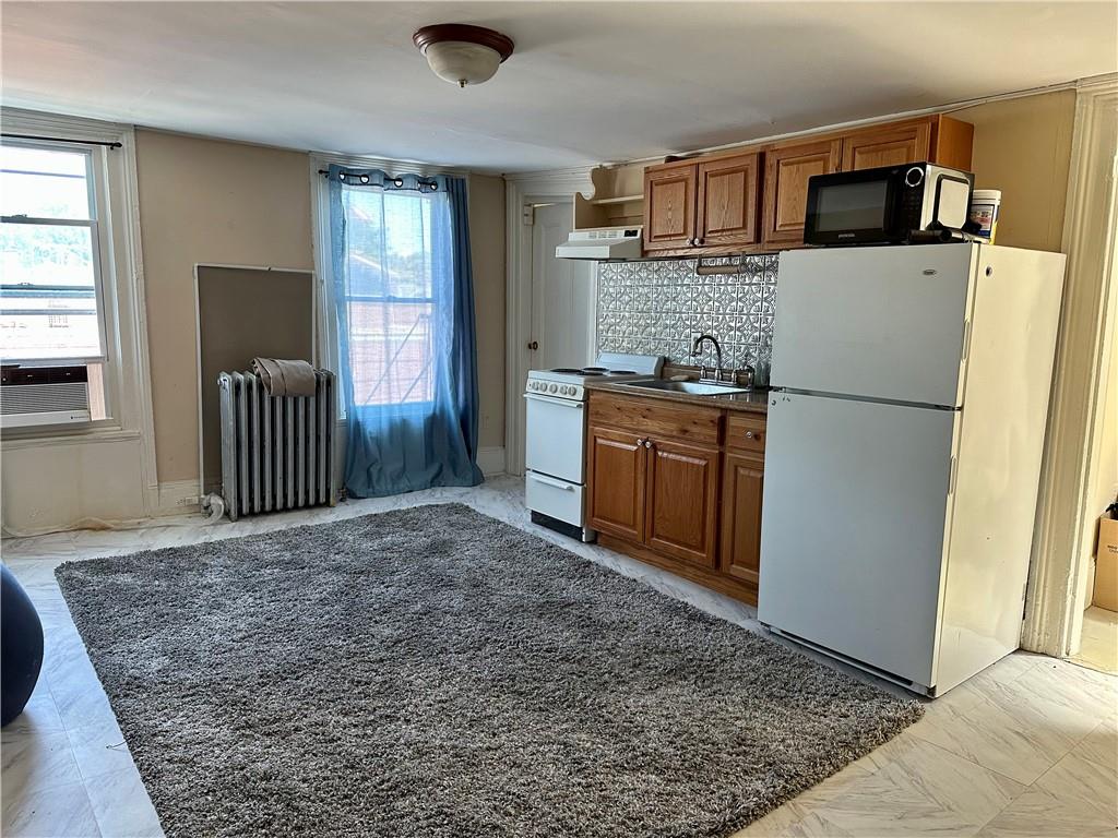 a kitchen with a refrigerator and a sink