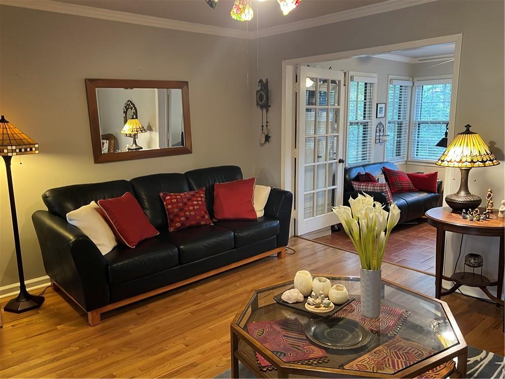 a living room with furniture and wooden floor