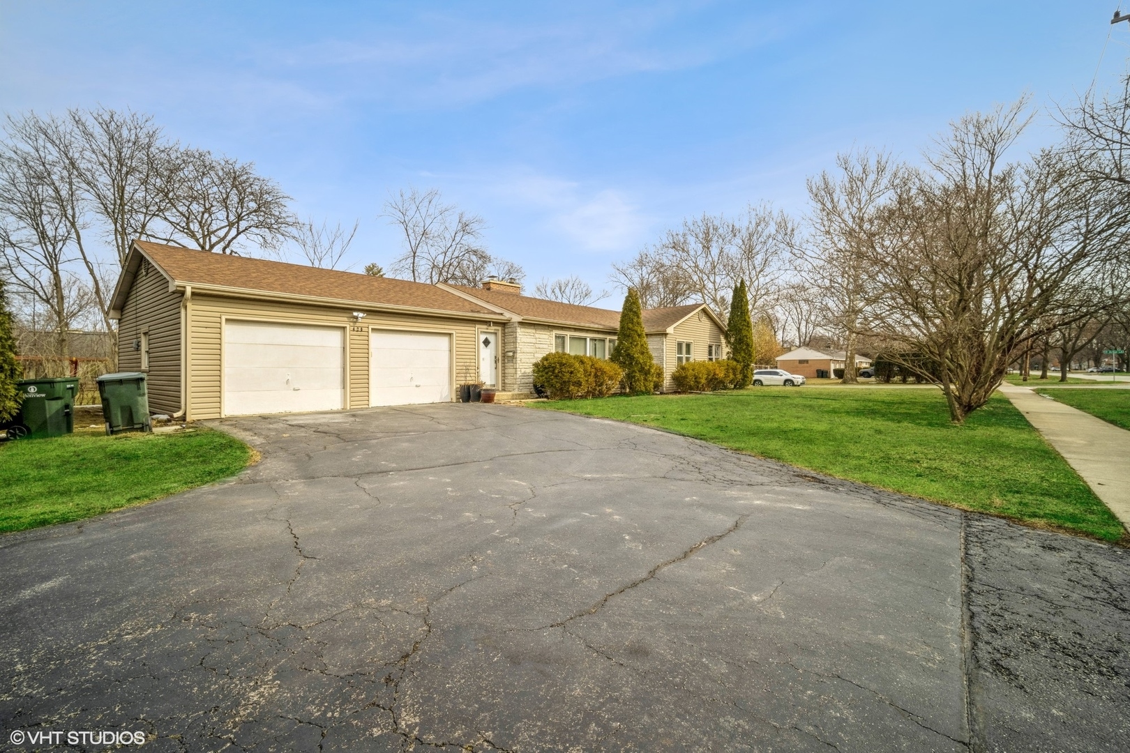 a front view of house with yard and green space