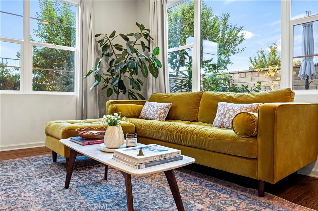 a living room with furniture and a potted plant