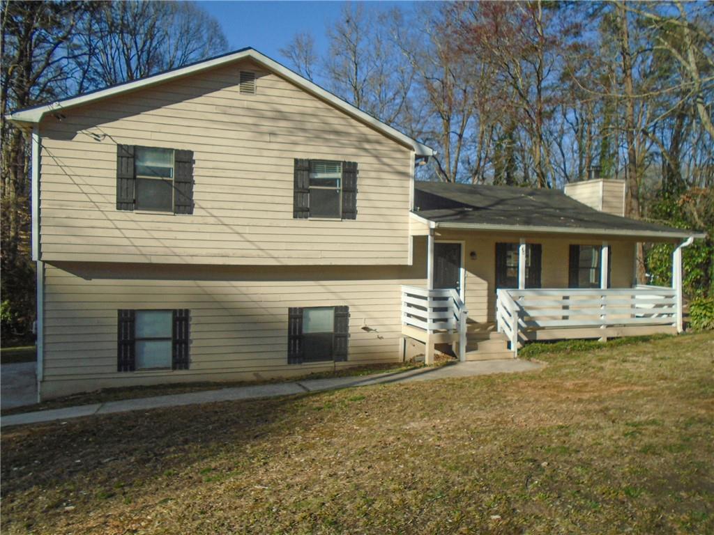 a view of house with yard