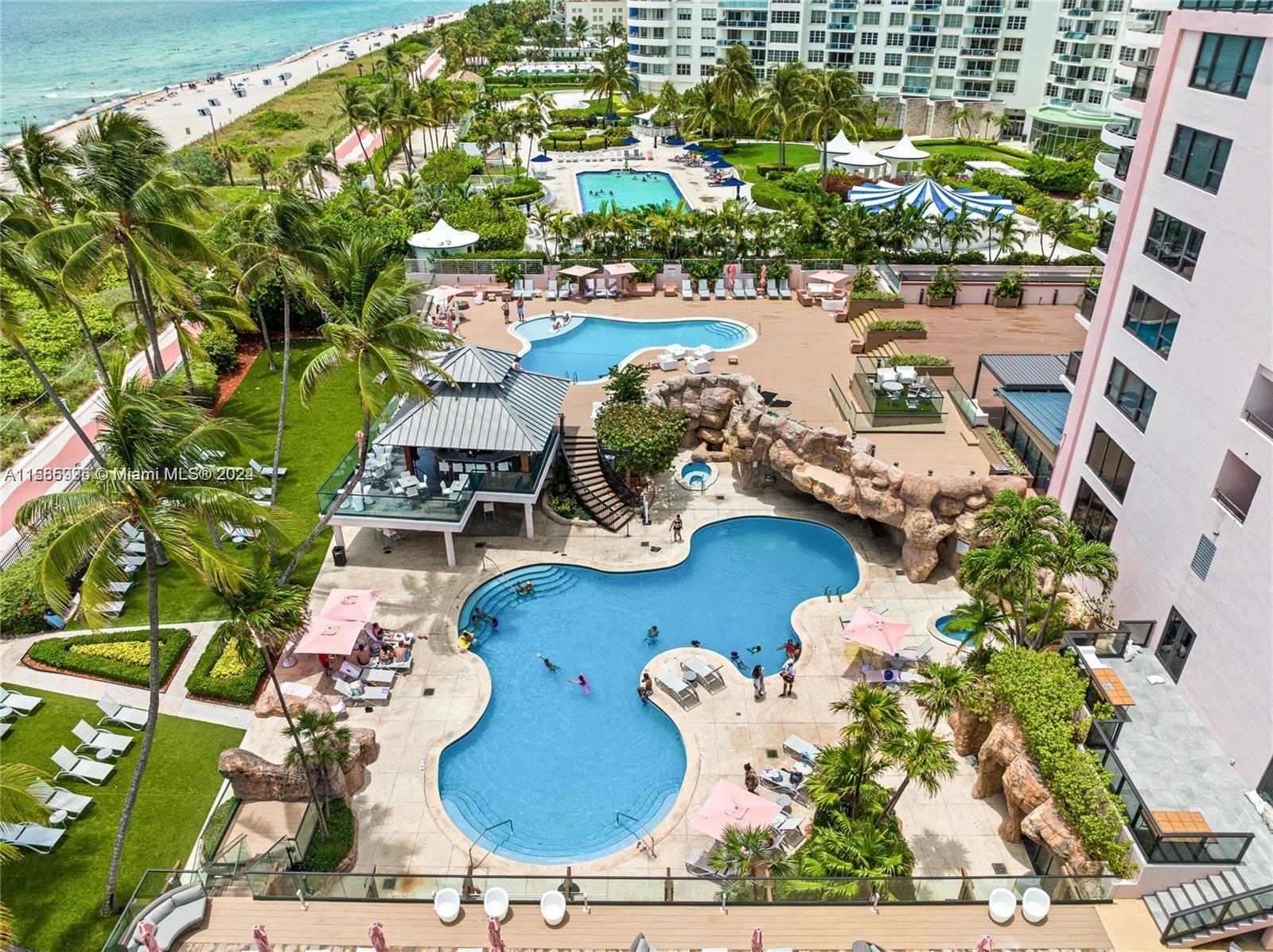 an aerial view of a house with yard swimming pool and outdoor seating