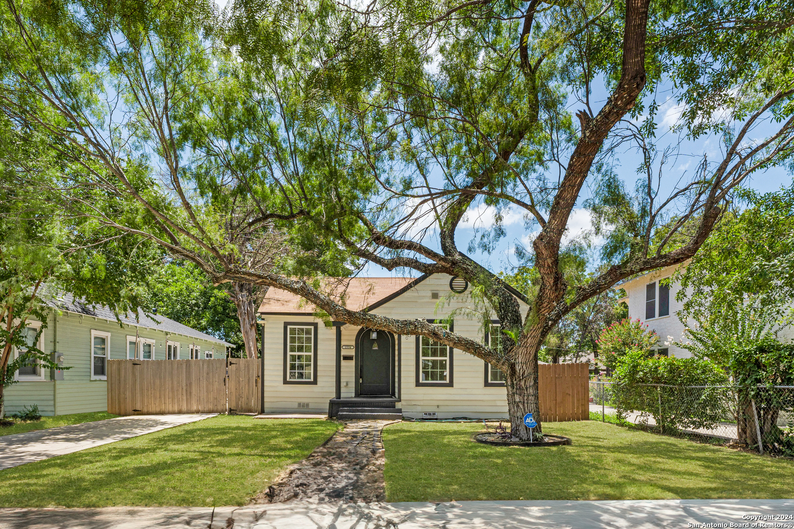 front view of a house with a tree