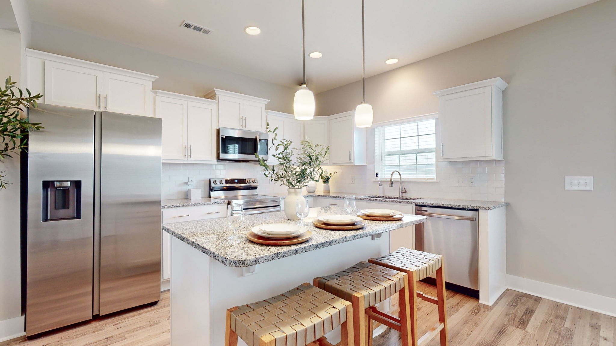 a kitchen with sink refrigerator and microwave