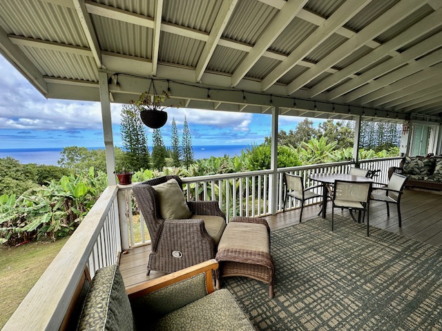 a roof deck with table and chairs