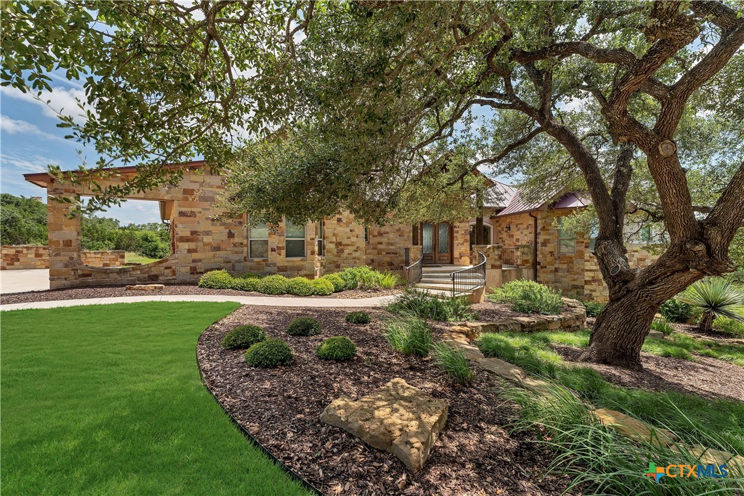 a front view of a house with garden