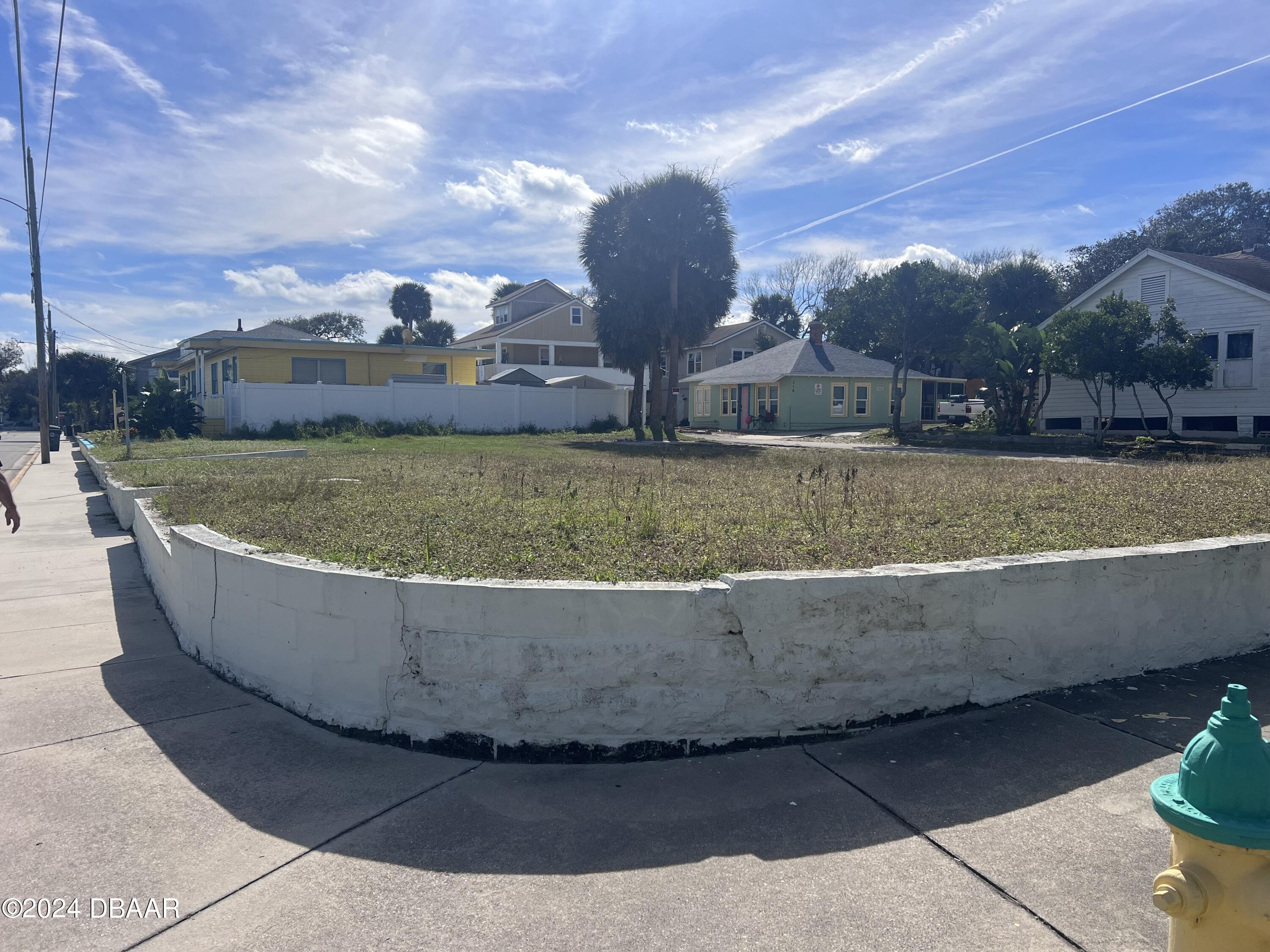 a view of a house with a yard and sitting area