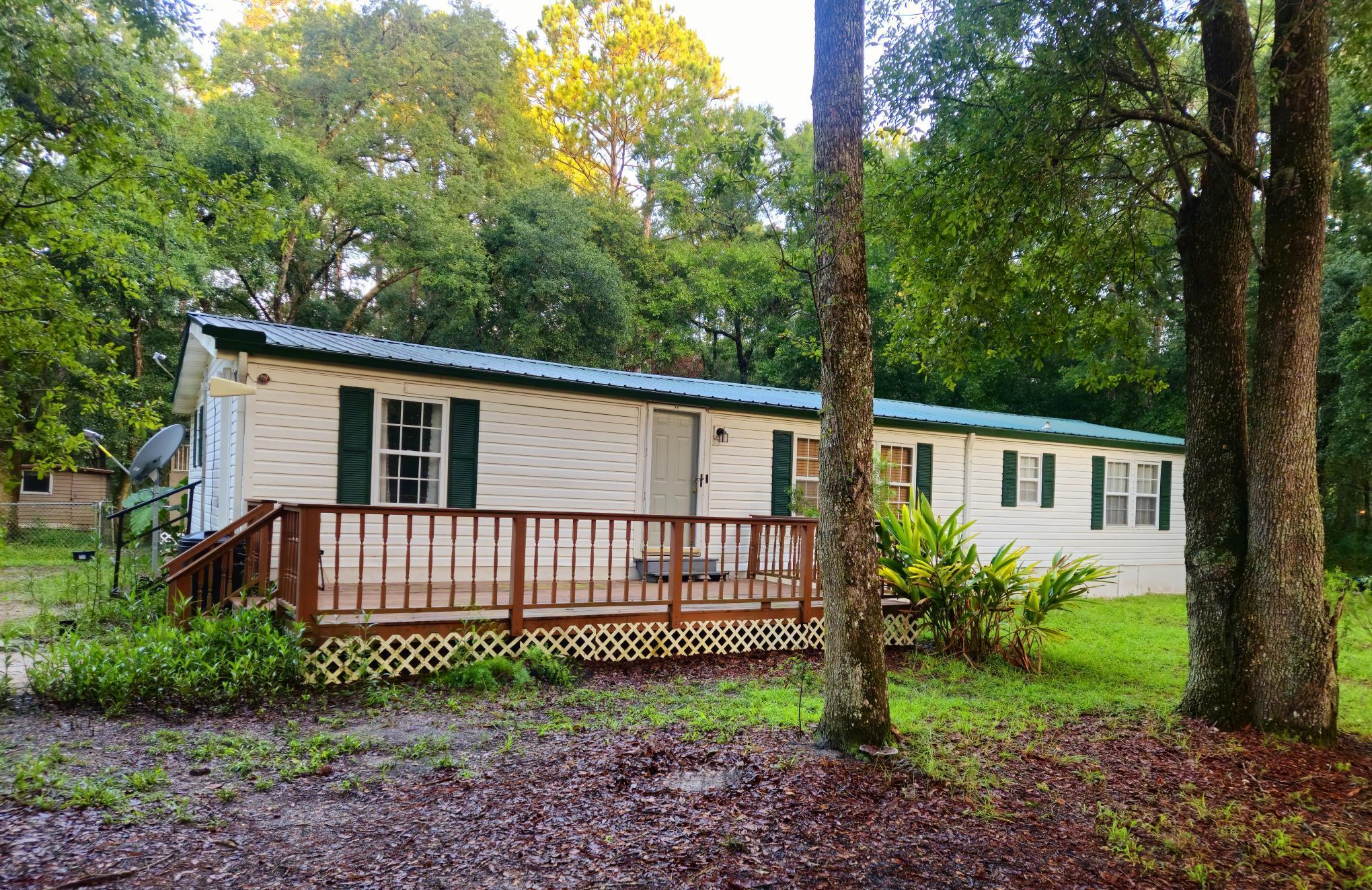 a view of a house with a yard and plants