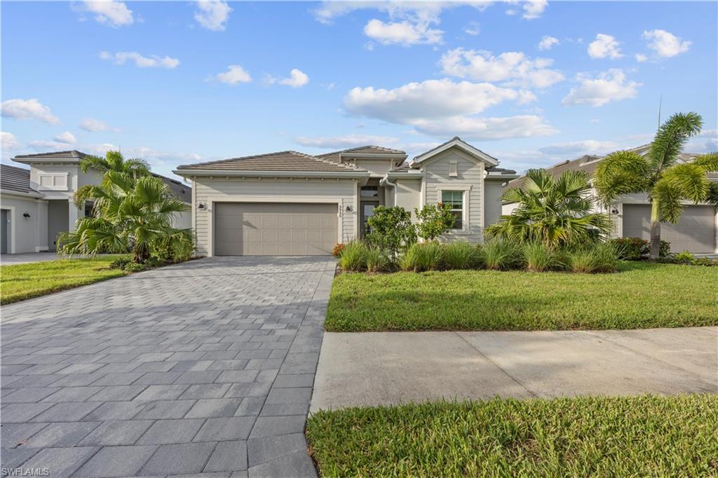 a front view of a house with a yard and garage