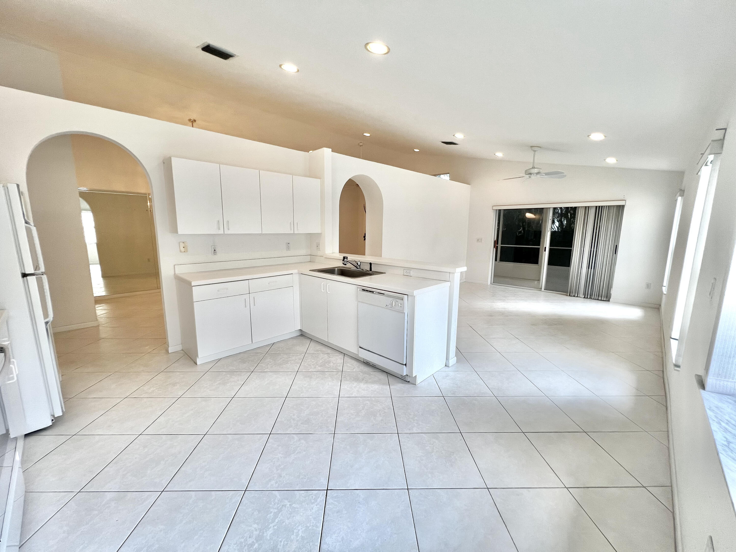 a kitchen with stainless steel appliances granite countertop a sink and a refrigerator