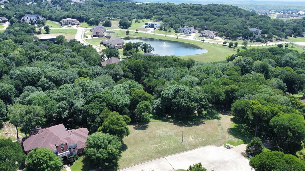 an aerial view of a house with a yard and lake view