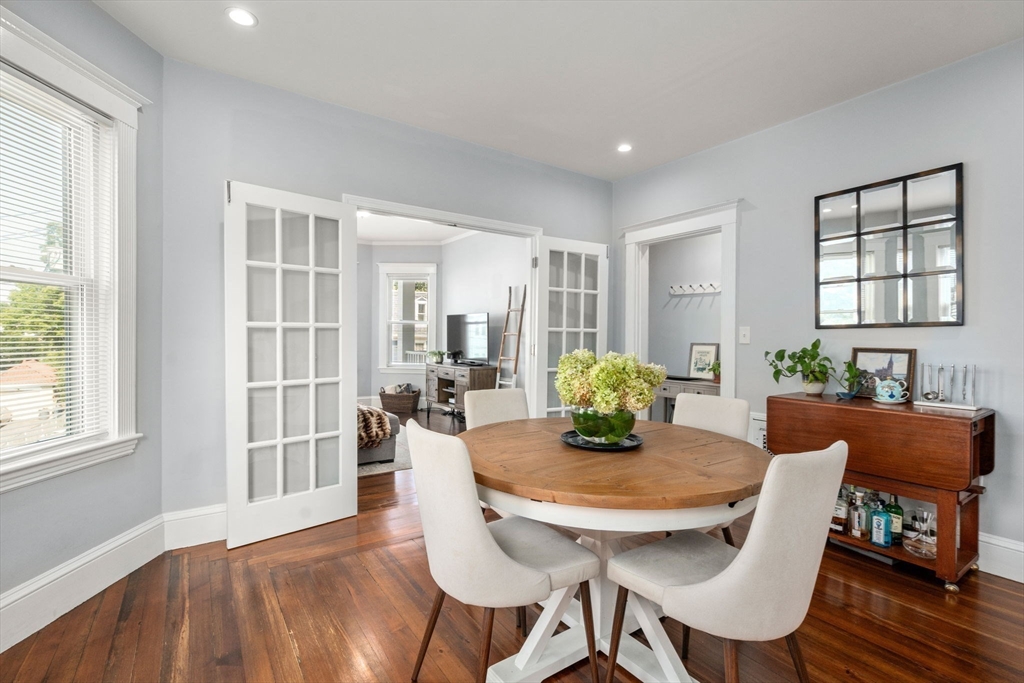 a view of a dining room with furniture and wooden floor