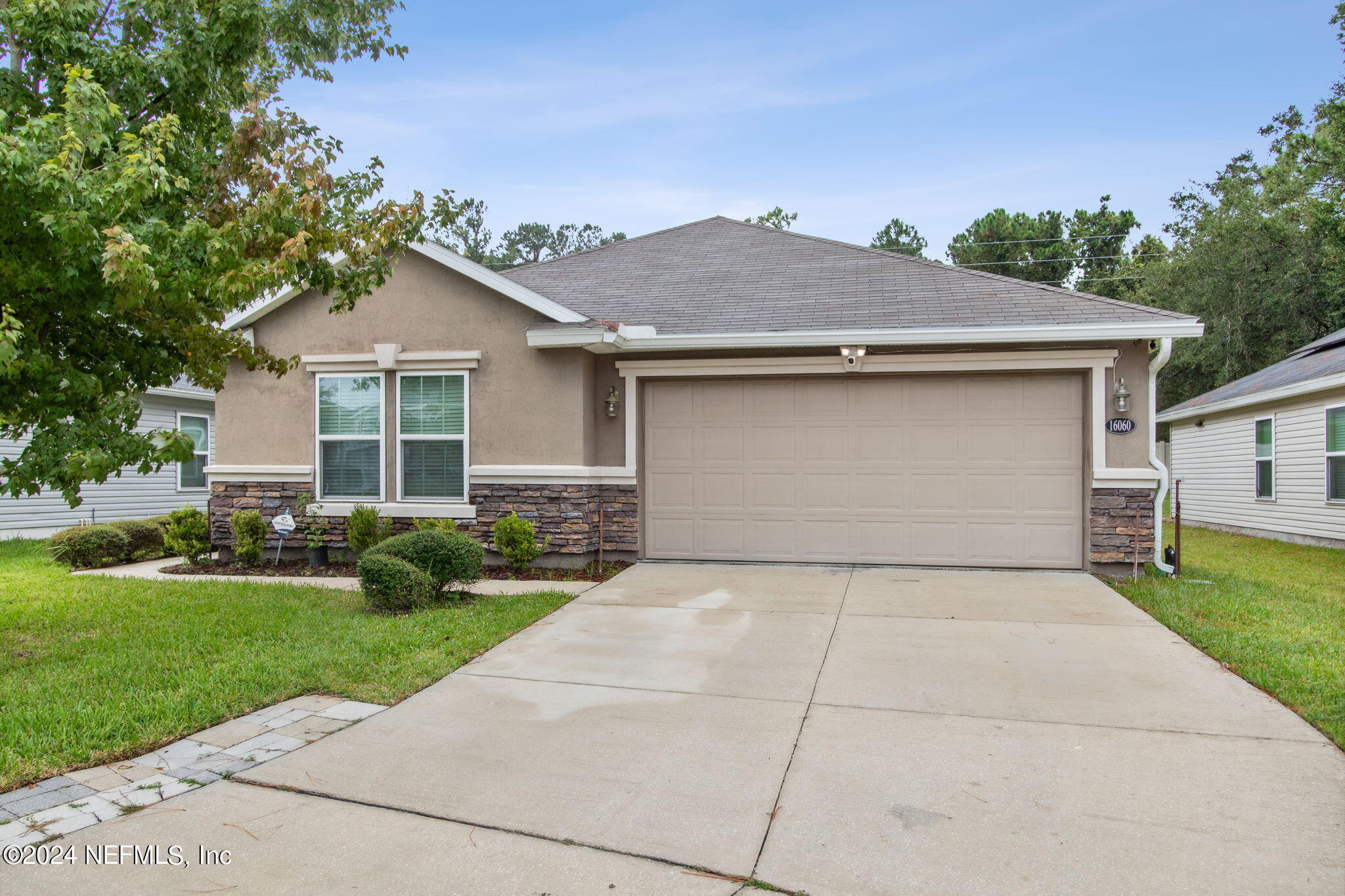 a front view of a house with a yard and garage