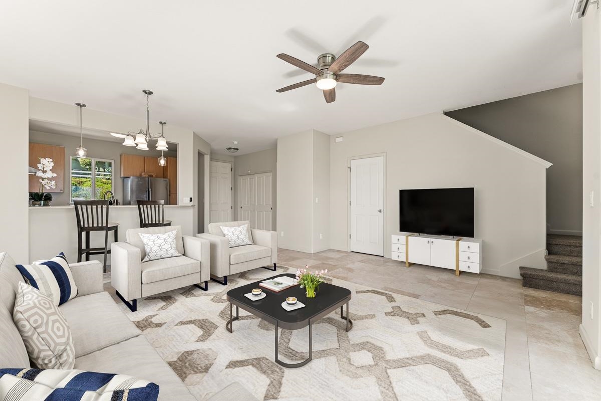 a living room with furniture a rug and a flat screen tv