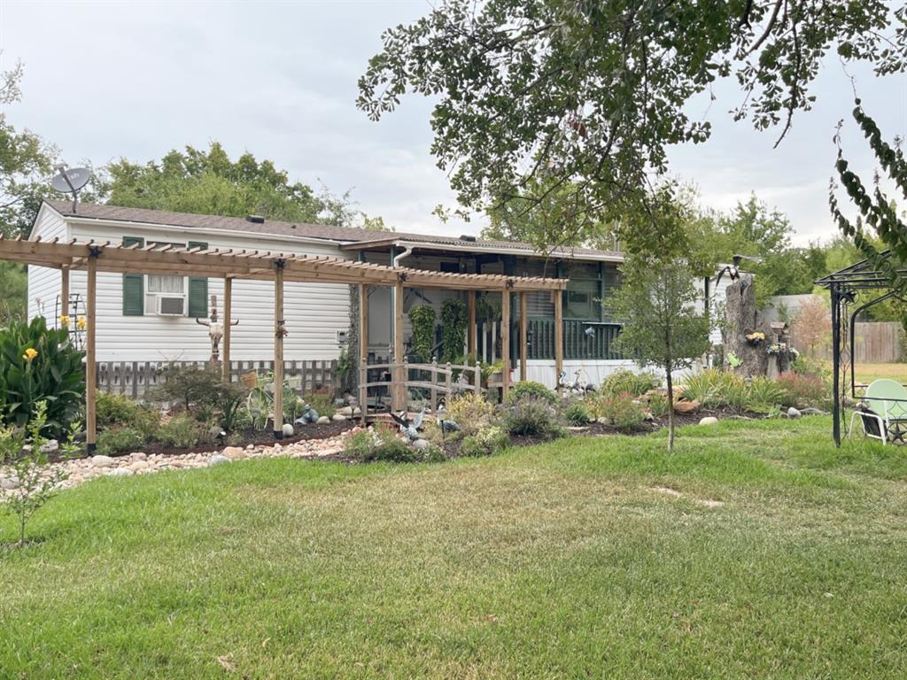 a view of a house with backyard sitting area and garden