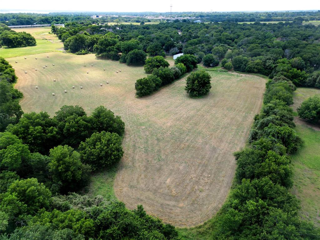 an aerial view of a house with yard