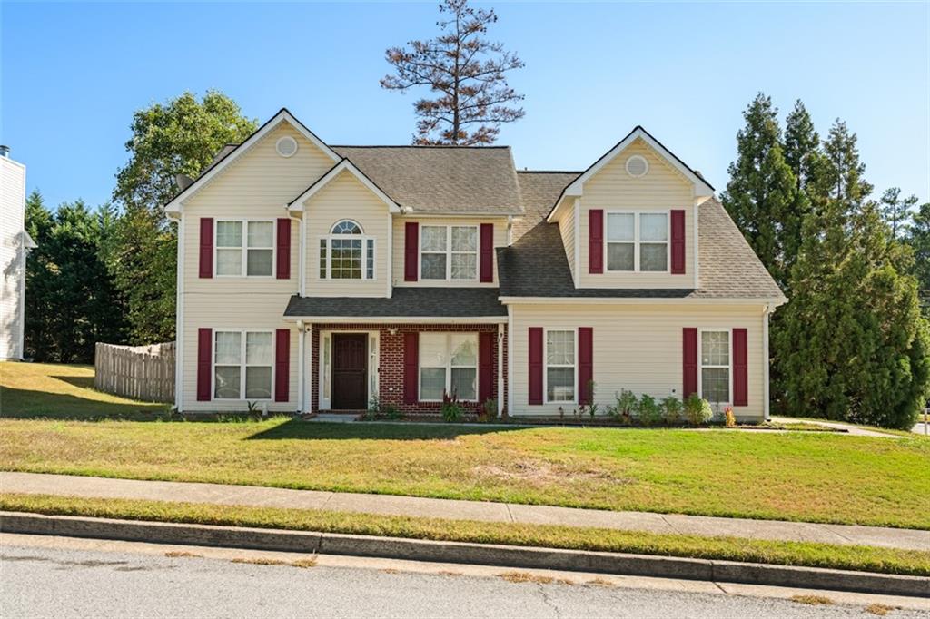 a front view of a house with a yard