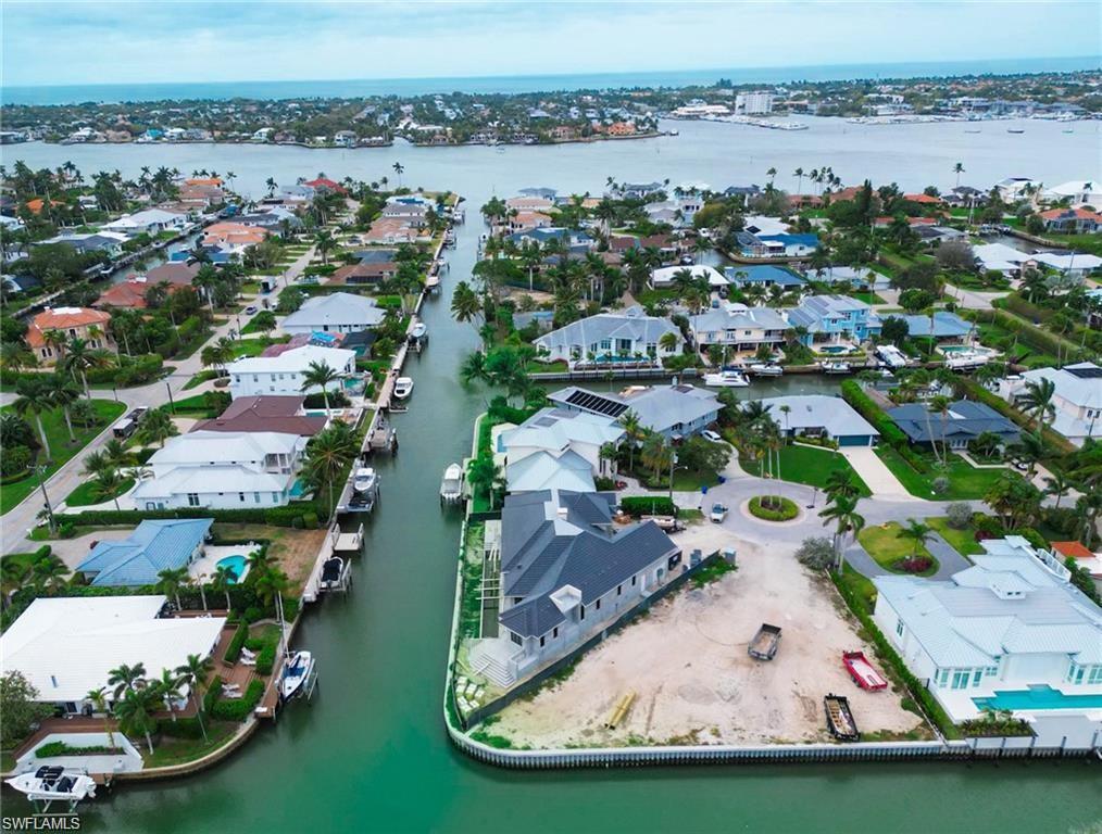 an aerial view of a house with a garden and lake view