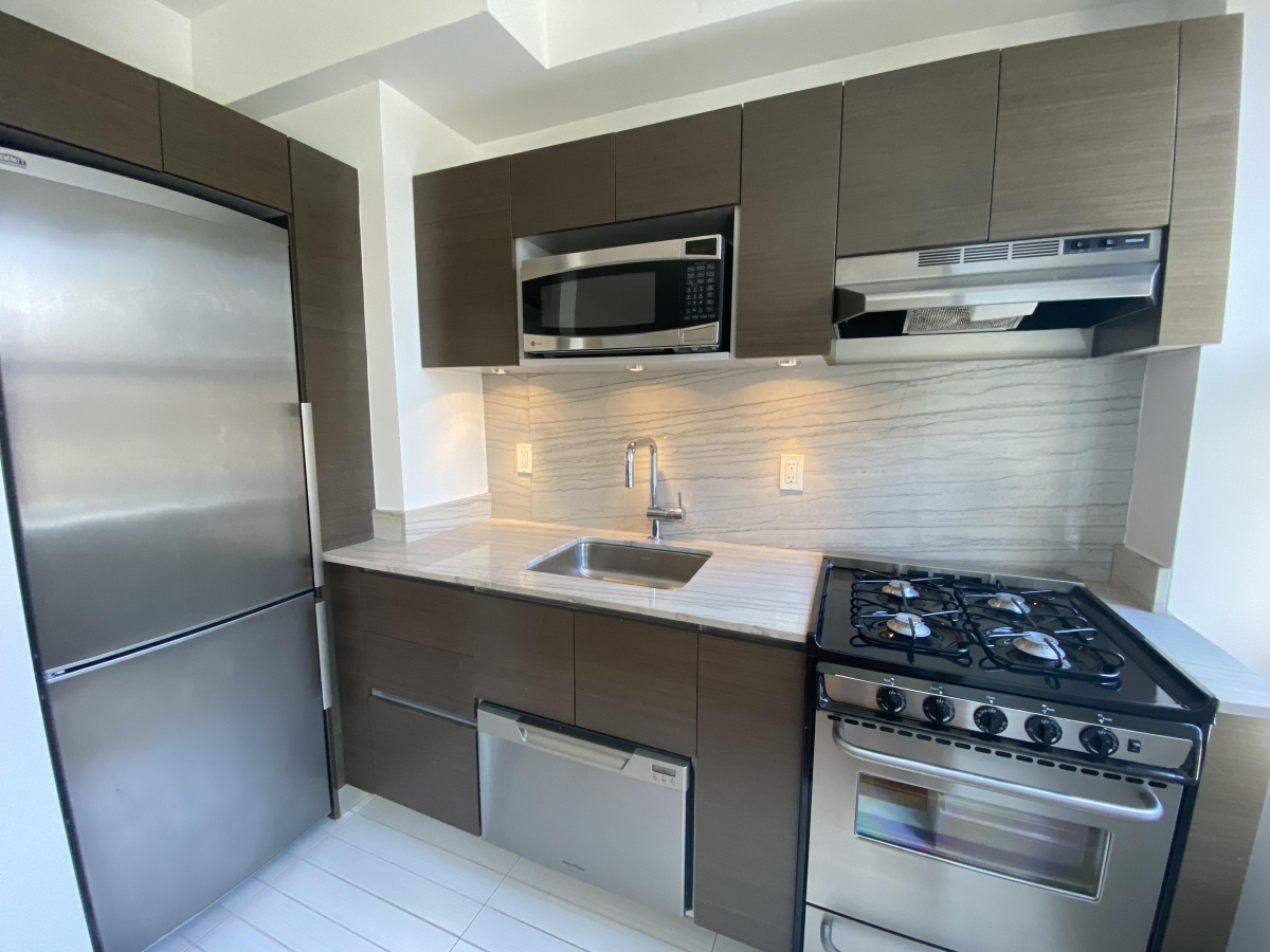 a kitchen with cabinets and steel stainless steel appliances