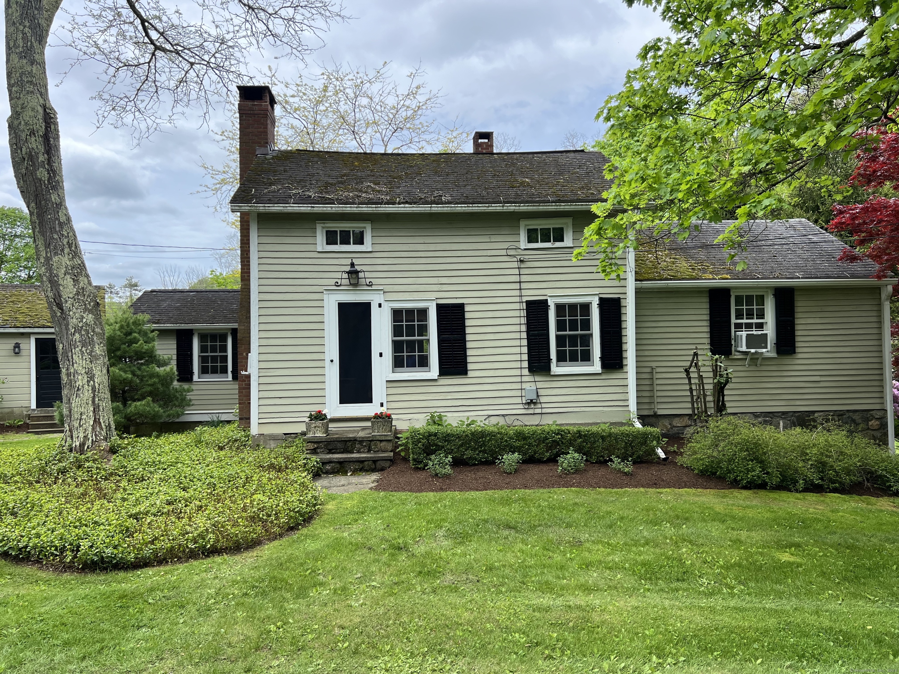 a front view of a house with a garden