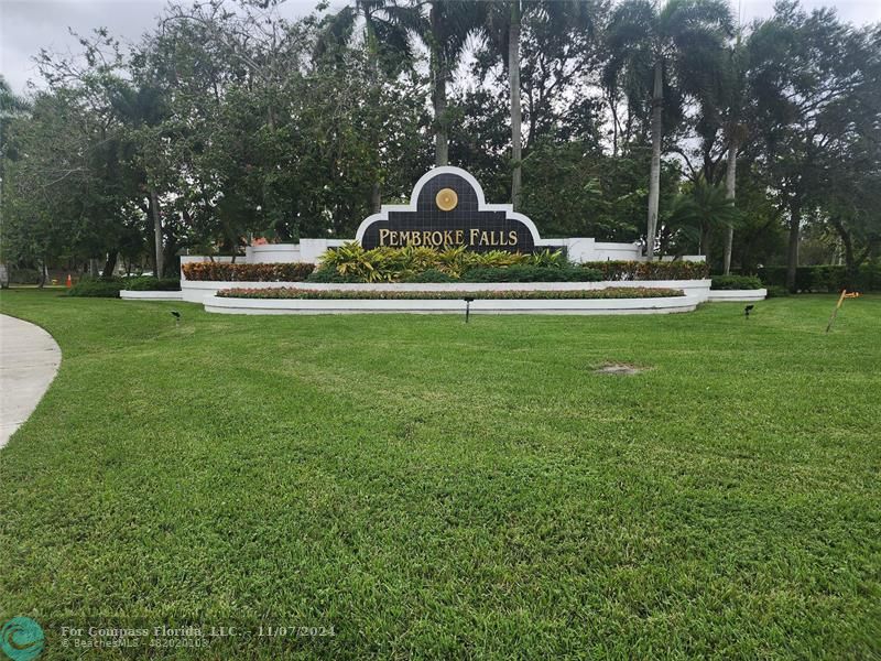 a garden with trees in the background