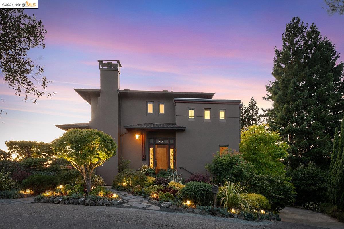 a front view of a house with a yard and outdoor seating