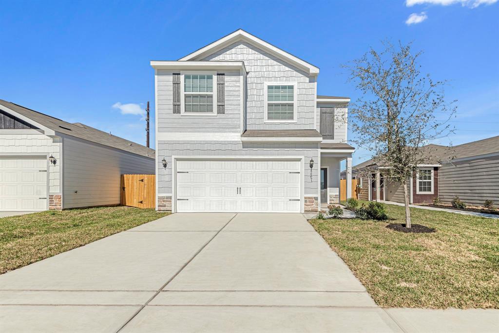 a front view of a house with a yard and garage