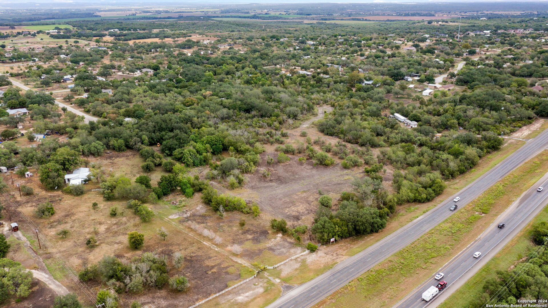 a view of a city with lush green forest