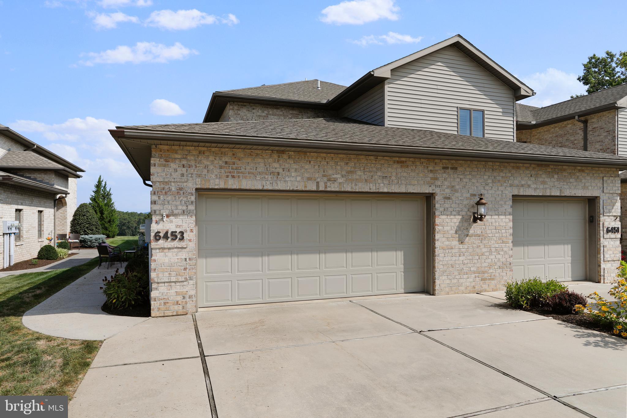 a front view of a house with garage