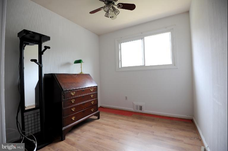 a room with a dresser and a chandelier