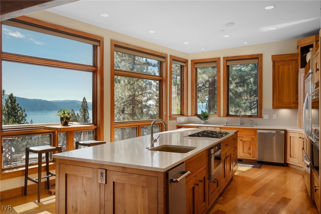 a kitchen with a stove a sink and a wooden cabinets