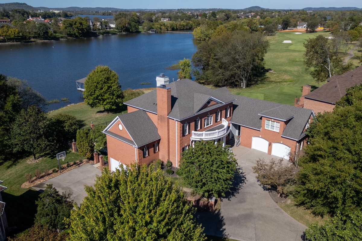 an aerial view of a house with garden space and lake view