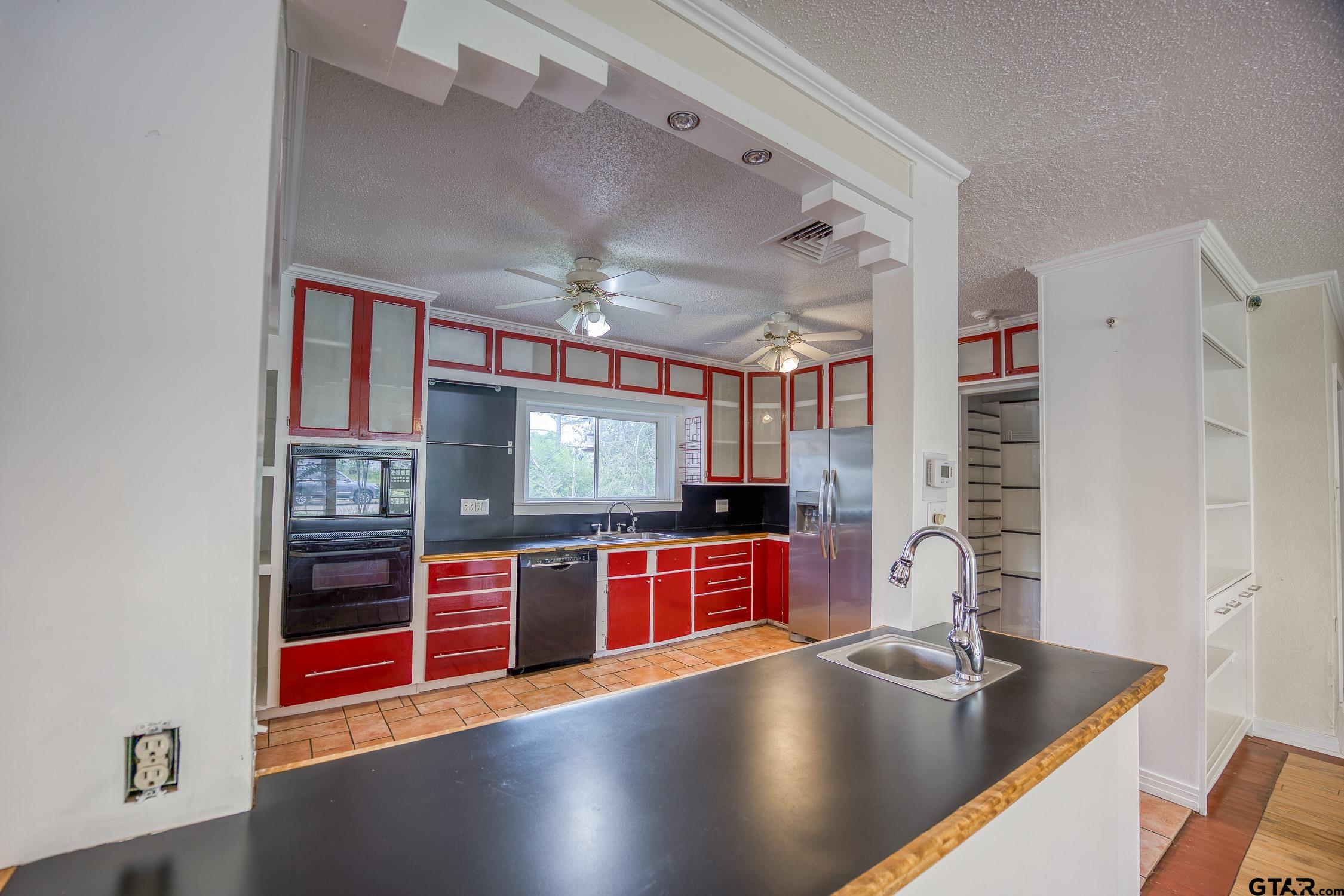 a kitchen with stainless steel appliances a sink and a microwave